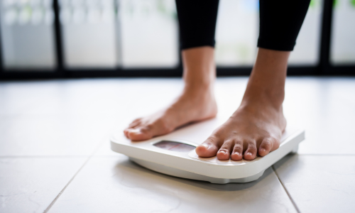 Image of a woman's feet on a weight scale.
